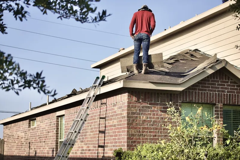 Professional roofer working on a residential roof in Pacifica